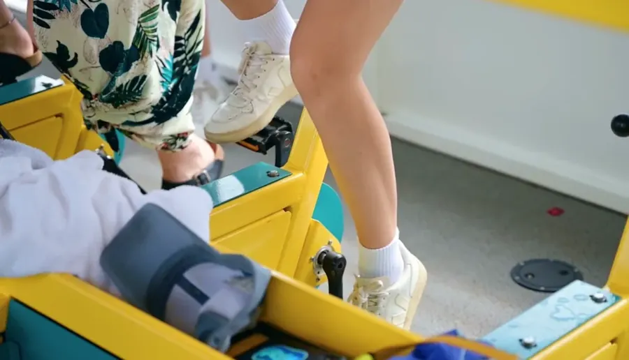 Woman in white sneakers with a yellow suitcase, ready for a trip on Paddle Pub